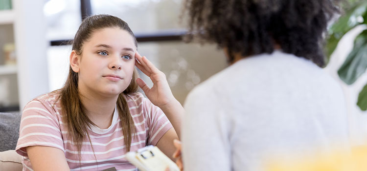 A student talks with a school counselor.mht