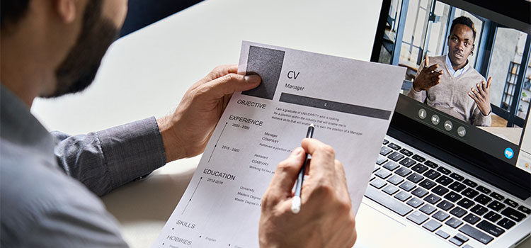 A man interviews for a job during a meeting online. line 