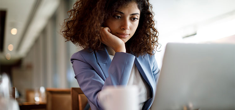 A woman looks for information on her laptop