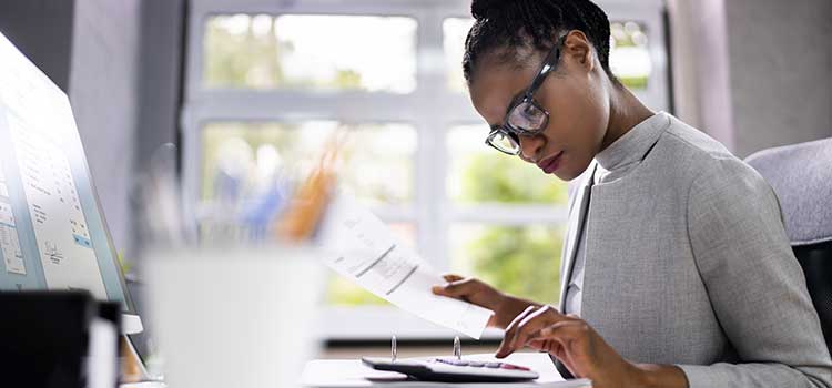 woman fillinf out licensing paperwork at desk