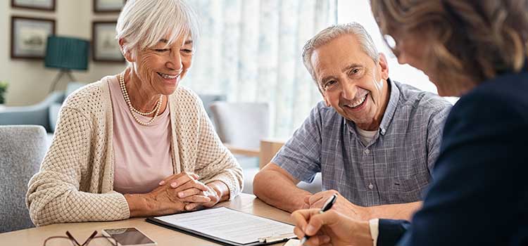 female financial planner discussing finances with older couple